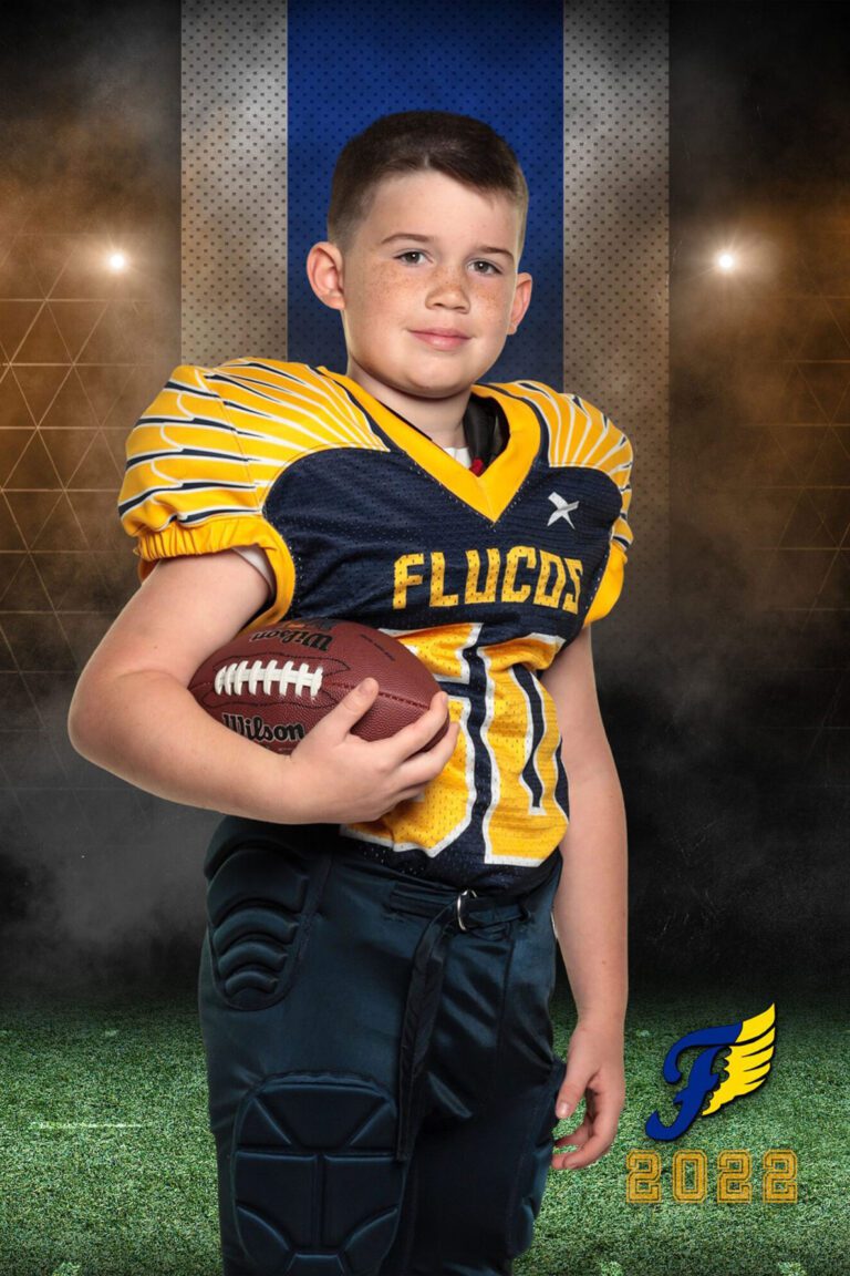 A young athlete posing for a sports league photo.