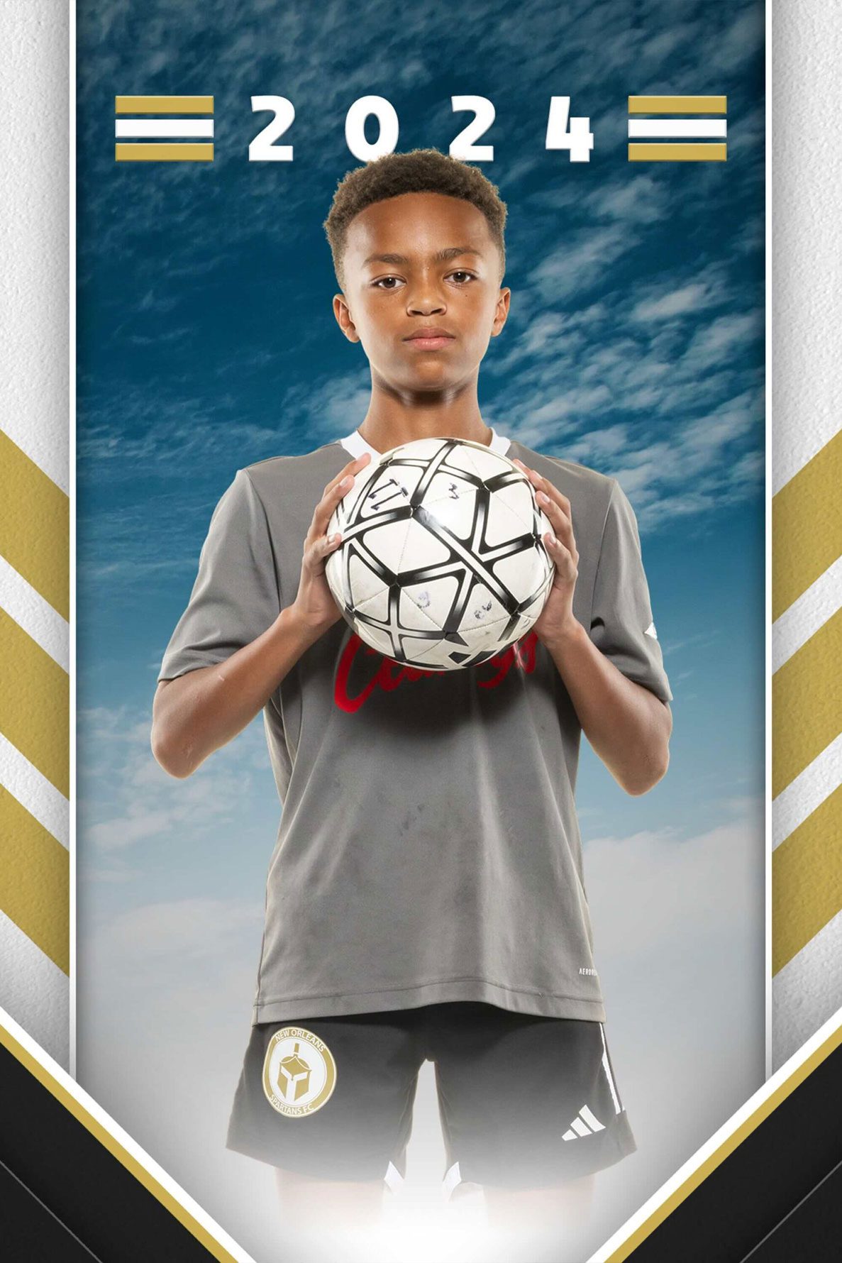 A youth soccer player poses with the soccer ball in a headshot