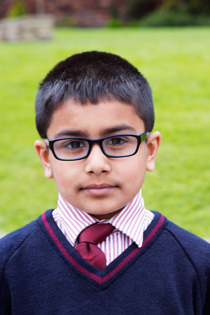 outdoor portrait of a young school boy in uniform