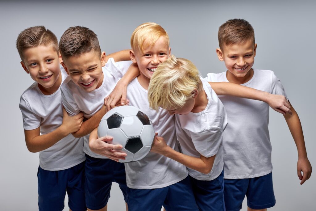 children soccer players have fun celebrating, smiling, enjoying sport games. football match, sport concept