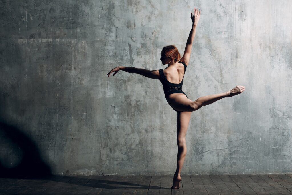 Ballerina female. Young woman ballet dancer, dressed in professional outfit, pointe shoes and black leotard.